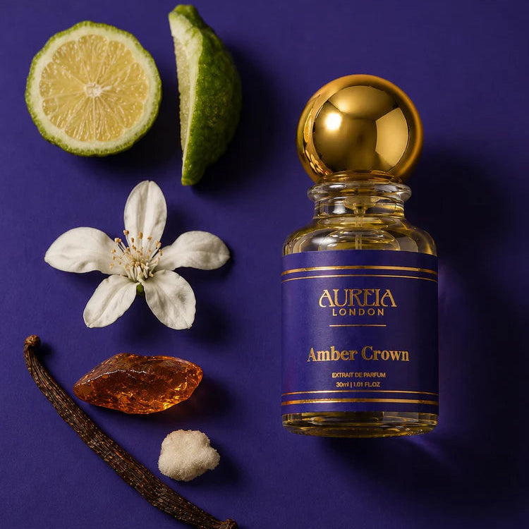 Aurora London Amber Crown perfume bottle with vanilla bean, lime, and flower on a purple background