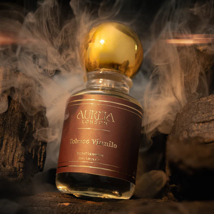 Aurora Edition Tobacco Viridio bottle with gold cap on a dark background with smoke