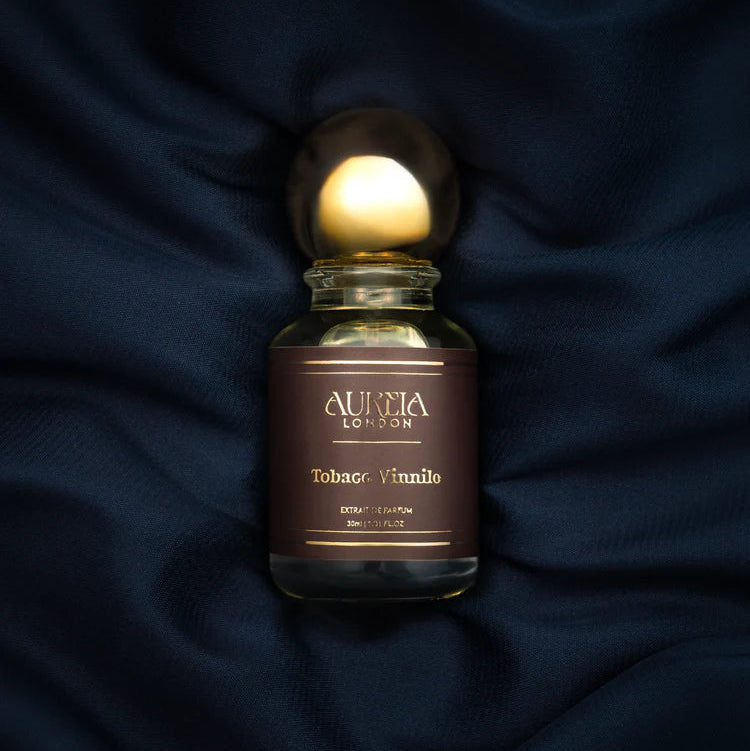 Aurita London Tobacco Vanilla perfume bottle on a dark fabric background