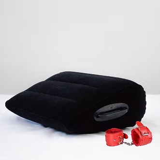 Black inflatable pillow with red handcuffs on a white background