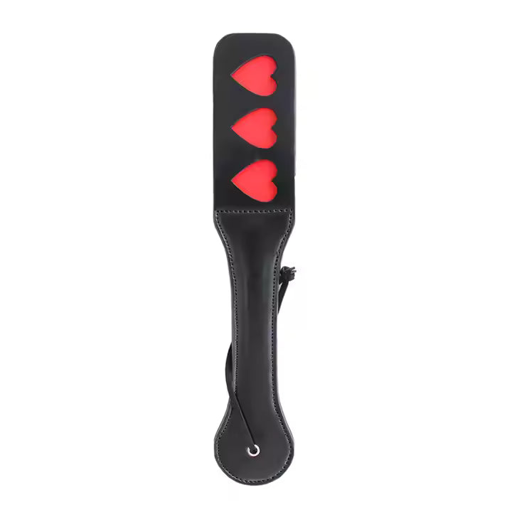 Black leather paddle with red heart designs on a white background