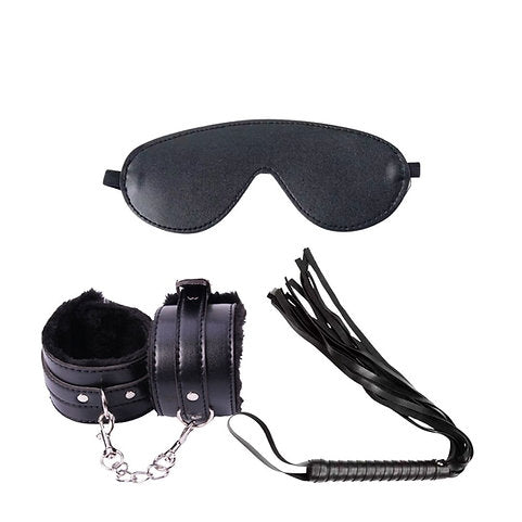 Black leather eye mask, handcuffs, and whip on a white background