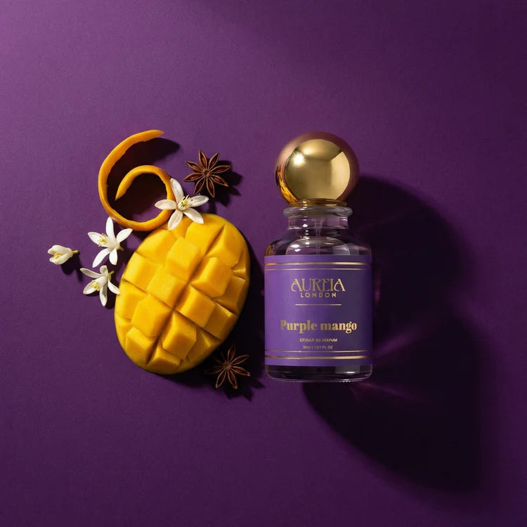 Perfume bottle labeled 'Purple Mango' with a mango and flowers on a purple background