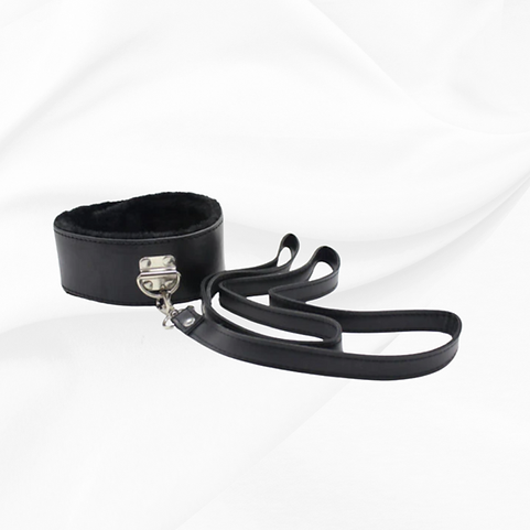 Black leather wrist cuff with attached strap on a white background