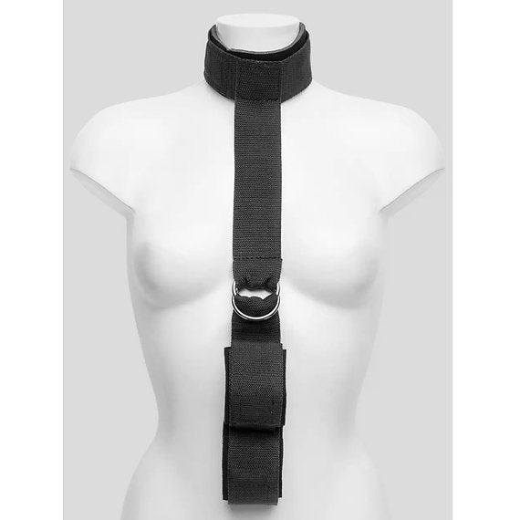 Black strap harness on a mannequin against a white background