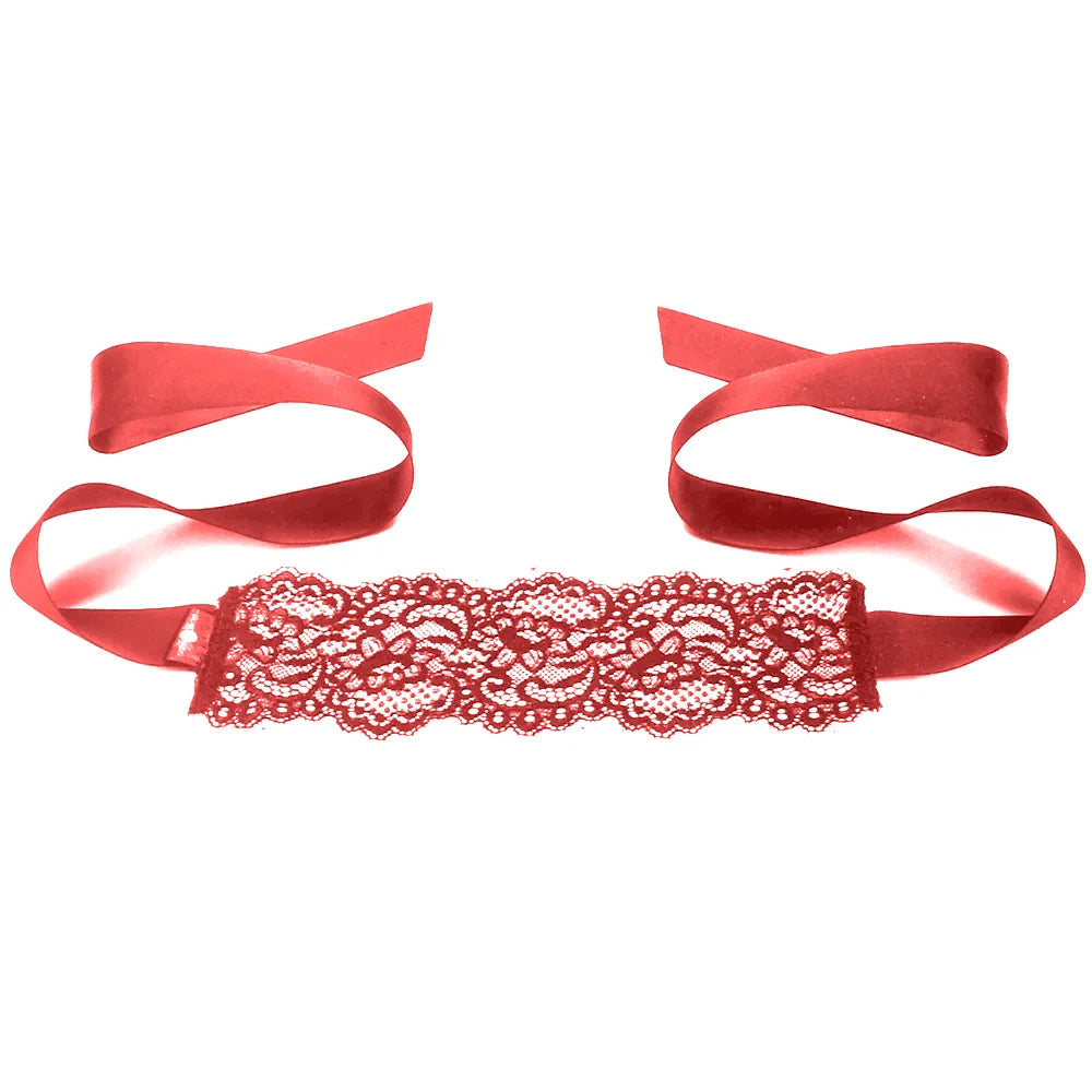 Red lace garter with ribbons on a white background