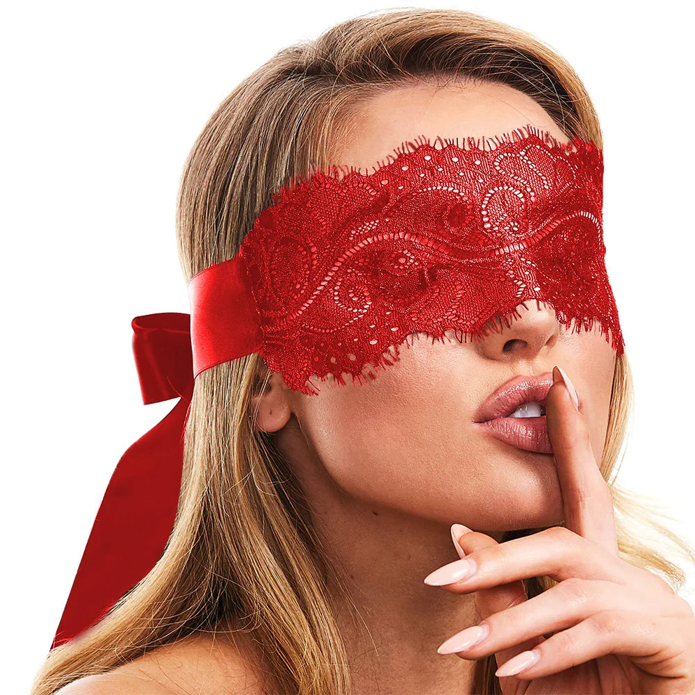 Woman wearing a red lace eye mask with a white background