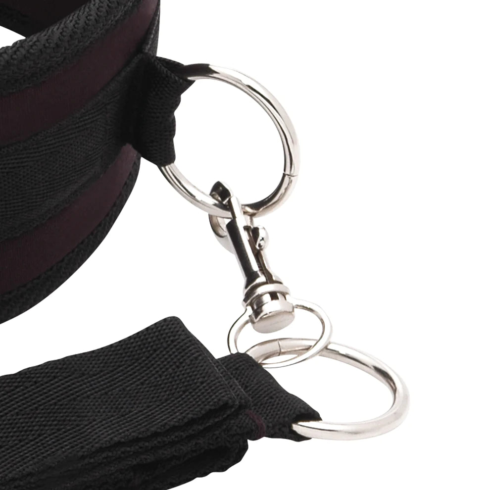 Close-up of a black lanyard with a metal clip on a white background