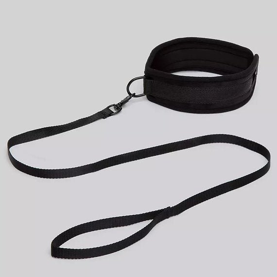 Black dog leash and collar set on a light gray background