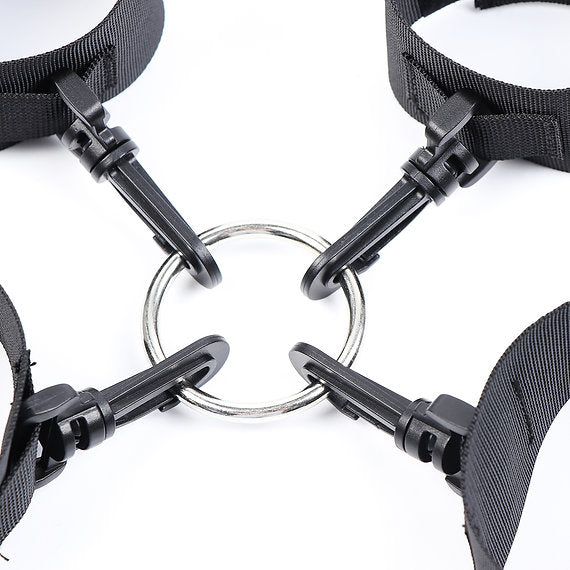 Close-up of black dog collars with metal buckles on a white background