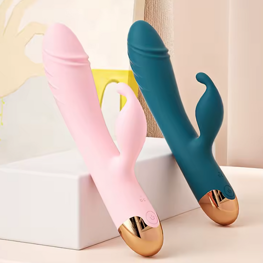 Pink and blue silicone tools with gold accents on a white surface