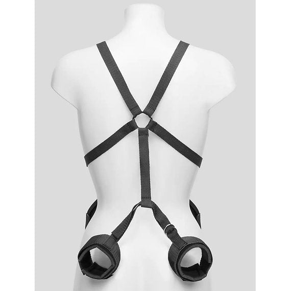 Black harness and cuffs on a mannequin against a white background