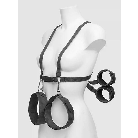 Black harness and cuffs on a mannequin against a white background
