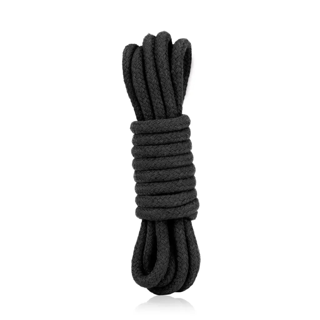 Coiled black rope on a white background