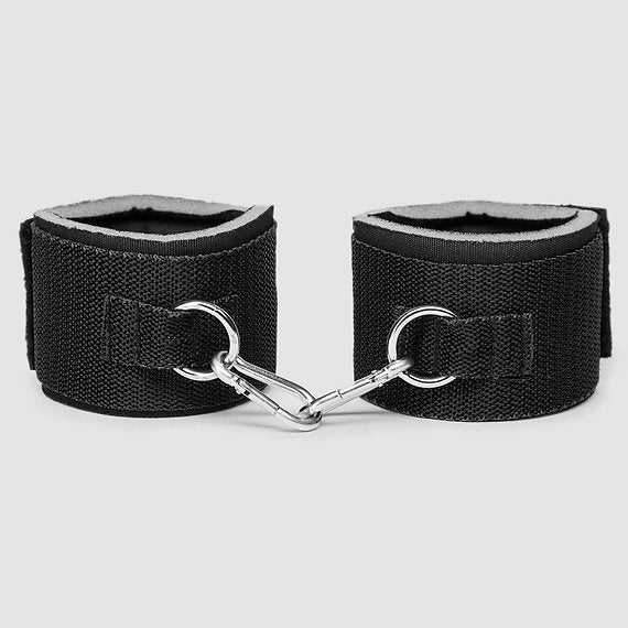 Black leatheranklets with silver hardware on a light gray background
