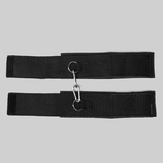 Two black belts with carabiners on a gray background